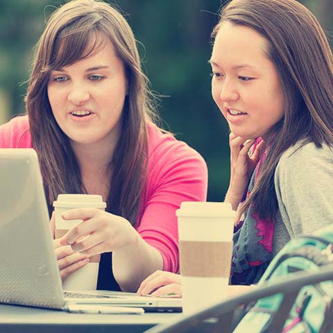 Two students looking at a laptop